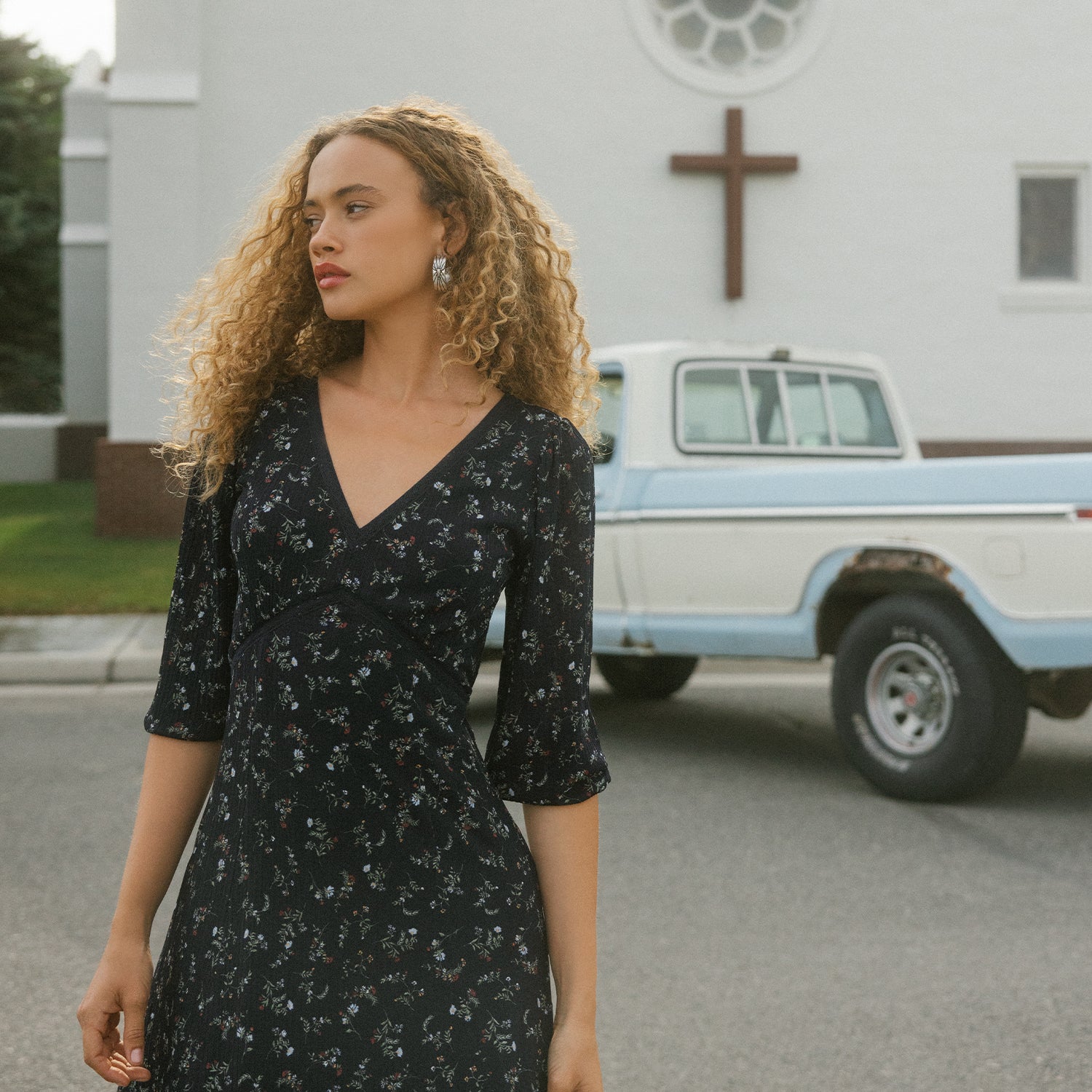 girl in a dress by a truck