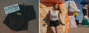Black shorts with a Nevada license plate labeled 'FLS LK LUCK' on a textured surface, and a woman in a white tank top and black shorts standing in front of colorful sculptures.